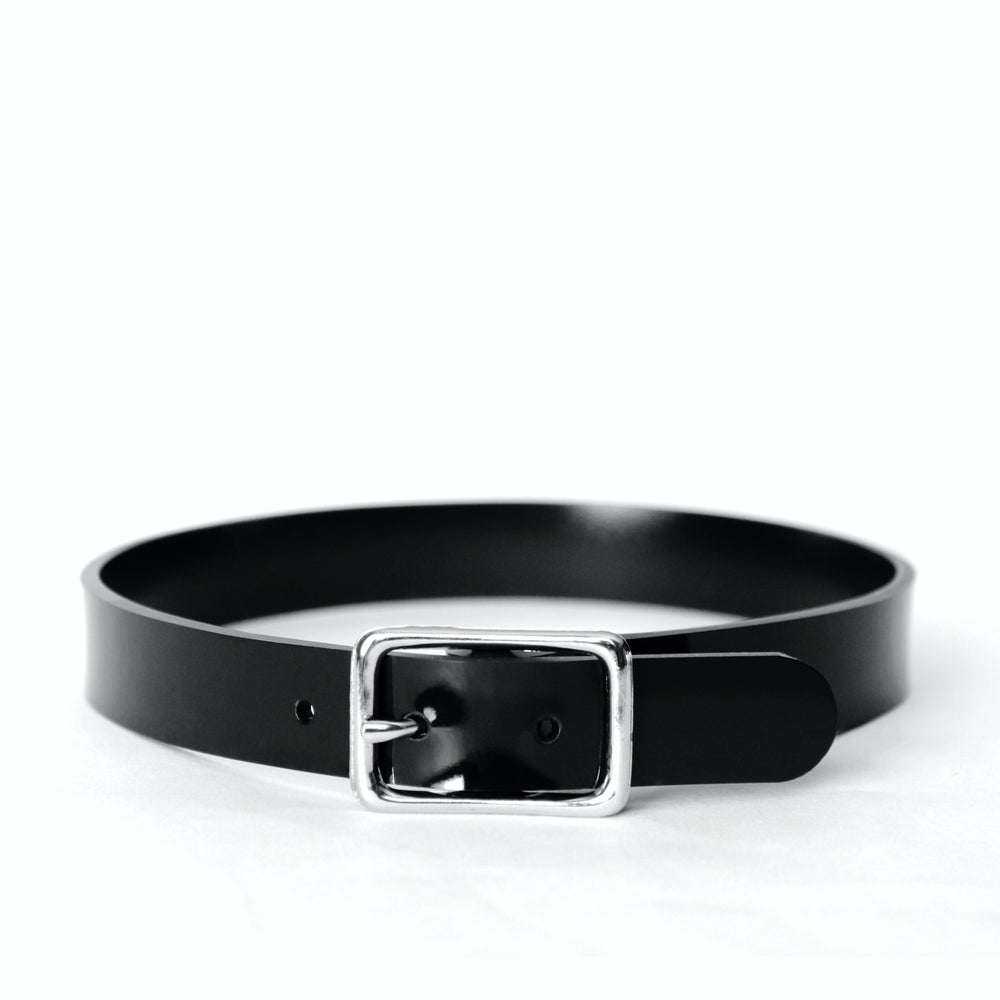 Faux leather choker with a silver buckle shown on a white background. Vegan leather gleams in the light.