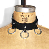 Dressform adorned with a black leather choker with three silver o-rings at the front.