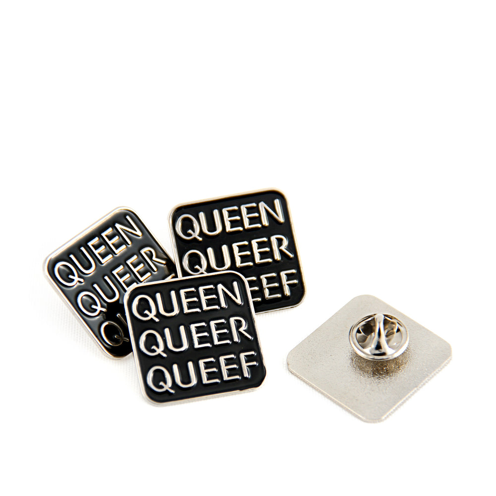 Four Q-Words pins on a white background. One pin is flipped over to show the single butterfly clutch pin back.