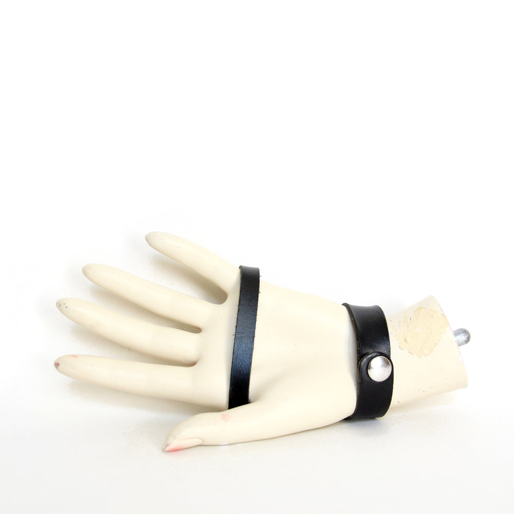 Palm view of black leather hand harness on mannequin