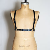 Black leather half suspender harness with silver hardware, front view