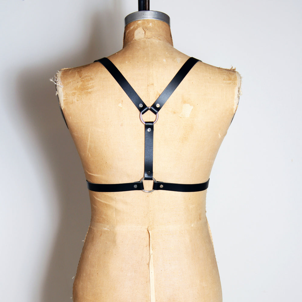 Black leather half suspender harness with silver hardware, back view