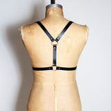 Black leather half suspender harness with silver hardware, back view