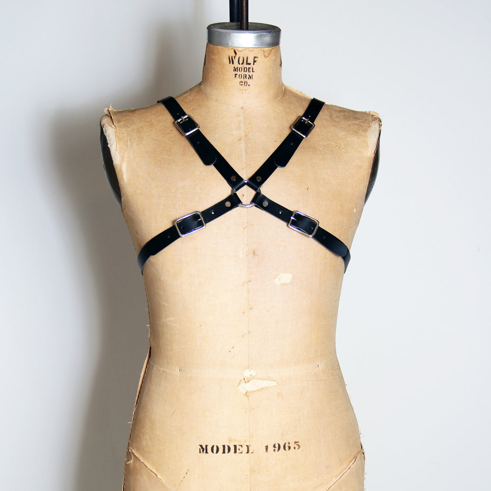 Black leather harness that makes an x across your chest