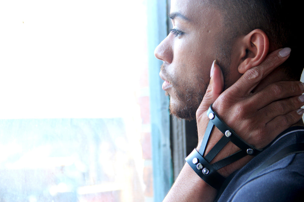 Model wearing black leather hand harness