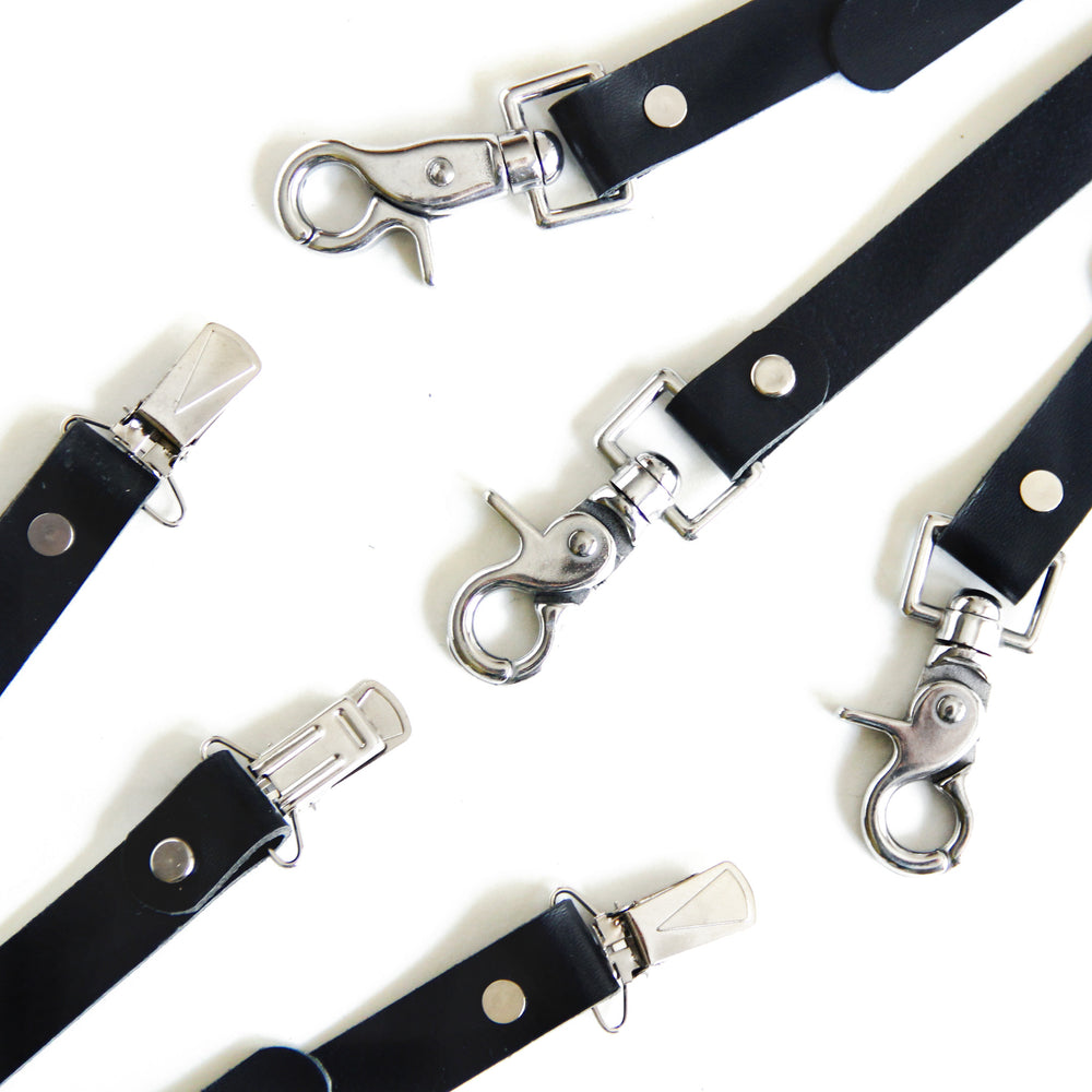 Close up of silver suspender clips and scissor clips