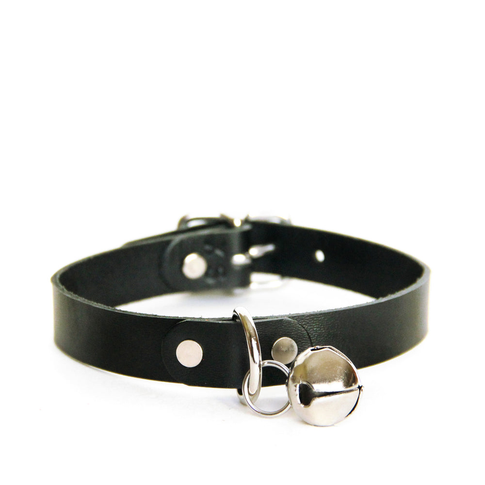 Front view of a black leather choker with silver hardware and silver jingle bell on a white background.