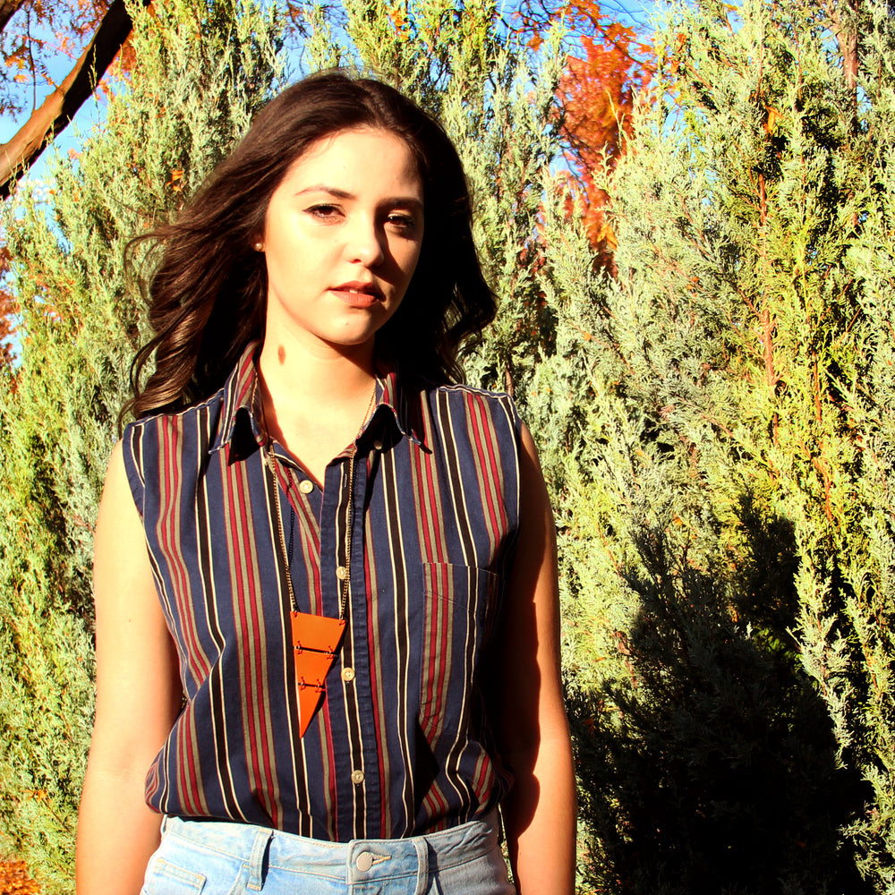 Model wearing orange leather cropped triangle neclace
