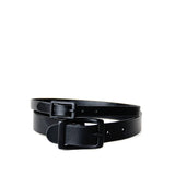 Two all black chokers stacked on top of one another on a white background.