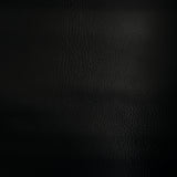 Swatch of black faux leather. Leather grain texture is visible on this swatch.