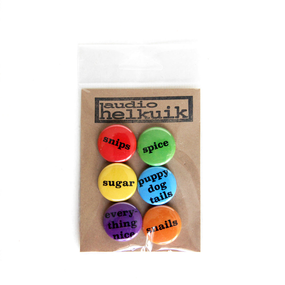 Pin set in the rainbow color way which includes red, orange, yellow, green, blue, purple. Shown in branded packaging.