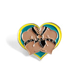 Heart-shaped enamel pin with silver metal. Heart is teal and yellow. Leather daddy wears a leather harness and leather gear.