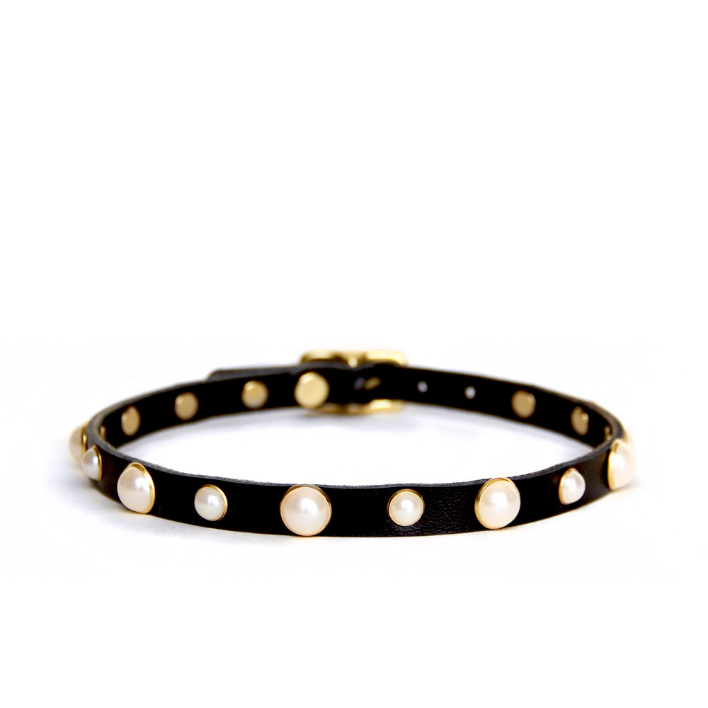 Black choker with pearl studs shown on a white background. Pearls are trimmed in brass.