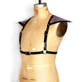 Black leather half suspender harness with silver hardware and mermaid leather triangle sholders, angled front view