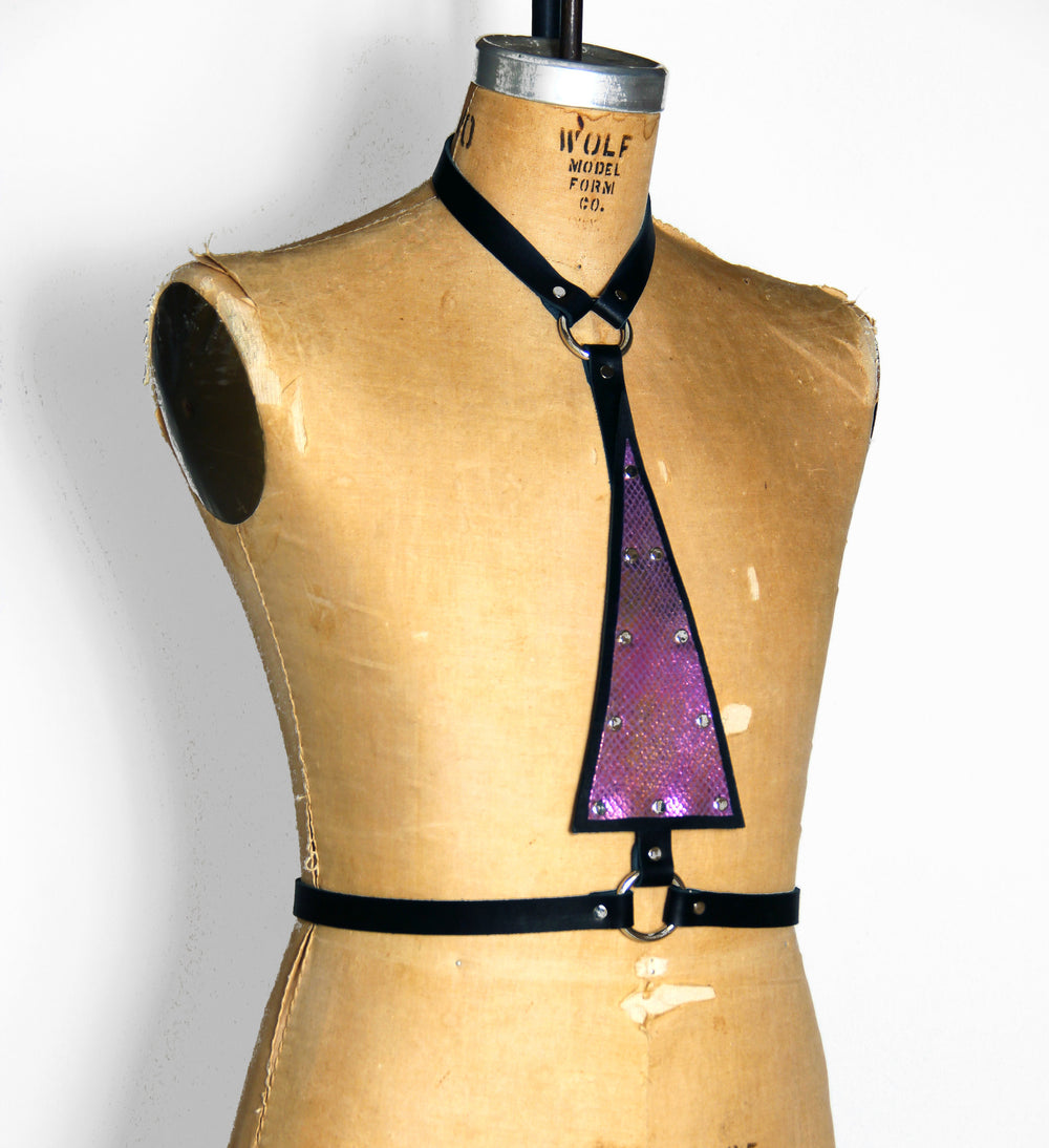 Black leather harness with upside down purple mermaid leather triangle in the center, angled front view