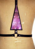 Black leather harness with upside down purple mermaid leather triangle in the center, close up