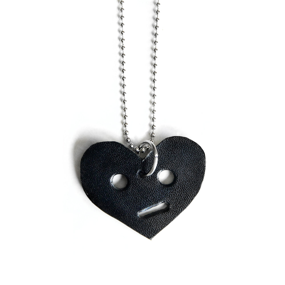 Leather heart necklace with circle eyes, close up