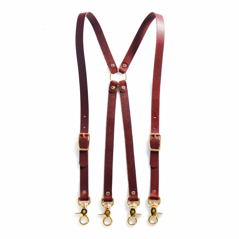 Chestnut brown leather suspenders with brass swivel trigger clips.